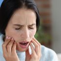 Woman with TMJ dysfunction and pain